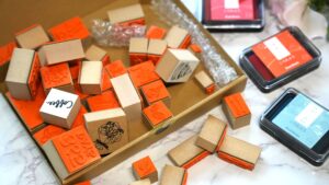 ラバースタンプをクラフトボックスや透明袋に可愛く梱包し、リボンやシールで装飾した写真